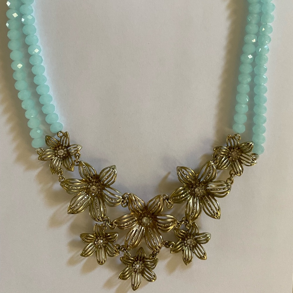 SOLD: Anthropologie gold jeweled flower necklace with blue beads.